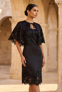 Black Lace Cape Dress – worn by model, travertine setting