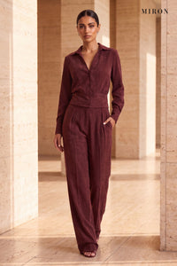 Burgundy Cupro Shirt & Trouser Set – worn by model, travertine setting